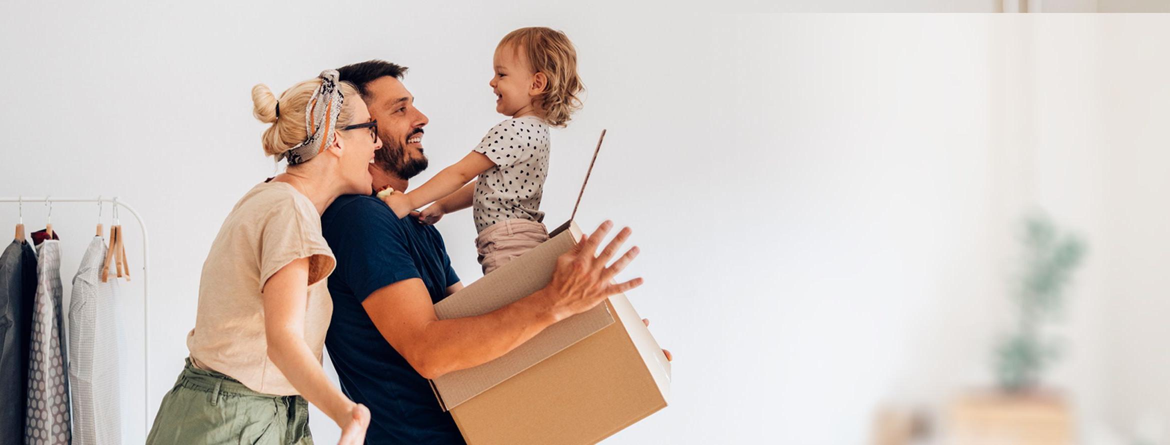 A baby surprises her parents when she pops out of a moving box.